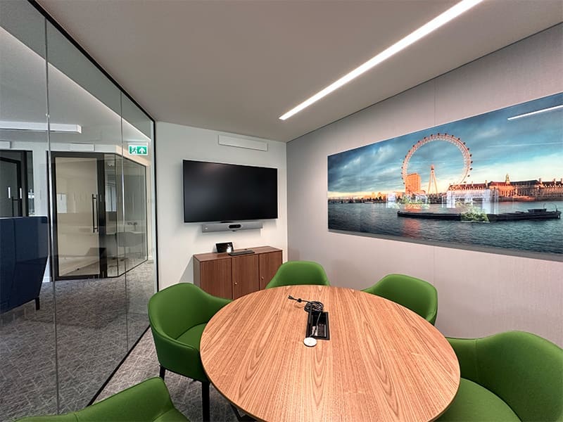 conference room with green chairs and a wooden table